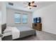 Bright bedroom featuring neutral tones, a comfortable bed, and ample natural light from the windows at 2043 Rock Maple Bnd, Kissimmee, FL 34746