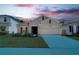 Charming single-story home featuring a well-manicured lawn and a two-car garage at 2043 Rock Maple Bnd, Kissimmee, FL 34746