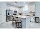 Bright kitchen featuring white cabinets, stainless steel appliances, and a center island with seating at 2043 Rock Maple Bnd, Kissimmee, FL 34746
