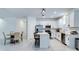 Modern kitchen with stainless steel appliances and a center island that opens up into the dining area at 2043 Rock Maple Bnd, Kissimmee, FL 34746