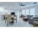 Bright open-concept living room and dining area with sliding doors and a ceiling fan at 2043 Rock Maple Bnd, Kissimmee, FL 34746