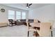 Spacious living room featuring a ceiling fan and a gray sofa next to a dining table at 2043 Rock Maple Bnd, Kissimmee, FL 34746