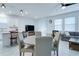 Open-concept living space with a modern kitchen, dining area, and cozy seating, perfect for entertaining at 2043 Rock Maple Bnd, Kissimmee, FL 34746