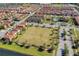 An aerial view of a meticulously planned community, showcasing homes, a pool, a playground, and green spaces at 2122 Bent Grass Ave, Ocoee, FL 34761