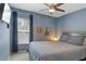 Comfortable bedroom featuring a ceiling fan, window with blinds, and neutral colored walls at 2122 Bent Grass Ave, Ocoee, FL 34761