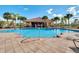Beautiful community pool with ample seating and lush tropical landscaping at 2122 Bent Grass Ave, Ocoee, FL 34761