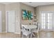 Cozy dining area featuring a white table, white chairs, tile flooring, and natural light at 2122 Bent Grass Ave, Ocoee, FL 34761