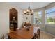 Dining room area featuring wood table with six chairs, tile floors and chandelier lighting at 2122 Bent Grass Ave, Ocoee, FL 34761