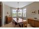 Well lit dining room with a stylish chandelier, cabinet and table with seating for six at 2122 Bent Grass Ave, Ocoee, FL 34761