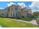 Charming two-story home with lush landscaping, stone accents, and a well-manicured lawn at 2122 Bent Grass Ave, Ocoee, FL 34761