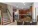Modern kitchen featuring dark cabinets, a breakfast bar, and stainless steel appliances at 2122 Bent Grass Ave, Ocoee, FL 34761