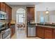 Lovely kitchen with dark wood cabinets, stainless steel appliances, and tile flooring at 2122 Bent Grass Ave, Ocoee, FL 34761
