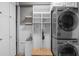 Well-organized laundry room with washer, dryer, sink, and storage shelves at 2122 Bent Grass Ave, Ocoee, FL 34761