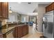 Open-concept living area visible from the kitchen featuring tile floors and comfortable furniture at 2122 Bent Grass Ave, Ocoee, FL 34761