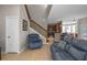 Spacious living room featuring a staircase, comfortable seating, and easy access to the kitchen at 2122 Bent Grass Ave, Ocoee, FL 34761
