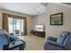 Open living room with tile flooring, comfortable seating, and sliding door access to the outdoor area at 2122 Bent Grass Ave, Ocoee, FL 34761