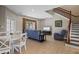 Bright and airy living room featuring tile flooring, comfortable seating, and a staircase with wood banister at 2122 Bent Grass Ave, Ocoee, FL 34761