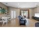Inviting living room featuring a comfortable sofa, tile floors, and sliding door to the patio at 2122 Bent Grass Ave, Ocoee, FL 34761