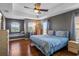 Main bedroom features a tray ceiling, wood floors, a window seat, and generous natural light at 2122 Bent Grass Ave, Ocoee, FL 34761