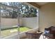 Screened patio with wicker chairs, overlooking a small grassy backyard at 2122 Bent Grass Ave, Ocoee, FL 34761