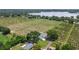 Stunning aerial view of a property nestled amongst lush fields with a lake in the background at 2190 Northland Rd, Mount Dora, FL 32757