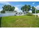 Expansive backyard with manicured lawn, white fence, and patio seating, ideal for outdoor activities at 2190 Northland Rd, Mount Dora, FL 32757