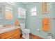 Cozy bathroom featuring a granite vanity, decorative mirror and accents, and a bathtub with bright orange shower curtain at 2190 Northland Rd, Mount Dora, FL 32757
