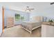 Peaceful bedroom with soft blue walls, a ceiling fan, and a scenic window view at 2190 Northland Rd, Mount Dora, FL 32757