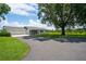 Charming ranch-style home with a two-car garage, lush green lawn and mature tree shading the front yard at 2190 Northland Rd, Mount Dora, FL 32757