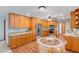 Well-lit kitchen with wood cabinets, stainless steel appliances, and breakfast nook perfect for casual dining and entertaining at 2190 Northland Rd, Mount Dora, FL 32757