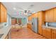 Spacious kitchen with wood floors, stainless steel refrigerator, and breakfast table; plenty of cabinet space for storage at 2190 Northland Rd, Mount Dora, FL 32757