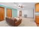 Cozy living room with a brown couch, ceiling fan, and unique blue accent wall at 2190 Northland Rd, Mount Dora, FL 32757