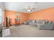 Inviting living room featuring a sectional sofa, rocking chair, large window, and colorful accent wall at 2190 Northland Rd, Mount Dora, FL 32757