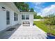 Charming patio with a cozy bench, decorative rug, and lush greenery, perfect for outdoor relaxation at 2190 Northland Rd, Mount Dora, FL 32757