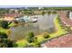 Aerial view of the community pool, pond and clubhouse, surrounded by lush landscaping and manicured lawns at 2662 Roadster Ln, Kissimmee, FL 34746