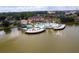 Aerial view of the community pool, pond and clubhouse, surrounded by lush landscaping and manicured lawns at 2662 Roadster Ln, Kissimmee, FL 34746