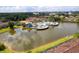 Aerial view of the community pool, pond and clubhouse, surrounded by lush landscaping and manicured lawns at 2662 Roadster Ln, Kissimmee, FL 34746