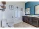 Contemporary bathroom featuring a toilet, vanity with sink, and decorative wall accents at 2662 Roadster Ln, Kissimmee, FL 34746