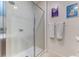 Bathroom featuring a tiled shower with glass door and a set of white towels at 2662 Roadster Ln, Kissimmee, FL 34746