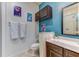 Bathroom with dark wood cabinets, light countertops, and blue accent wall at 2662 Roadster Ln, Kissimmee, FL 34746