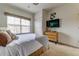 Bright bedroom with a neutral color scheme, TV, closet, and large window for natural light at 2662 Roadster Ln, Kissimmee, FL 34746