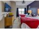 Bedroom with two twin beds, a TV, a dresser, and a ceiling fan at 2662 Roadster Ln, Kissimmee, FL 34746