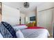 Bedroom featuring two twin beds with red blankets and white comforters, and a TV at 2662 Roadster Ln, Kissimmee, FL 34746