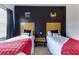 Bedroom with two twin beds, Lego decorations on the wall and light wood headboards at 2662 Roadster Ln, Kissimmee, FL 34746