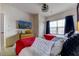 Bedroom featuring two twin beds with red blankets and white comforters, and a TV at 2662 Roadster Ln, Kissimmee, FL 34746