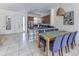 Dining area with seating for 10 adjacent to a modern kitchen at 2662 Roadster Ln, Kissimmee, FL 34746