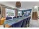 Bright dining room with seating for 10 and sliding glass doors leading to the pool area at 2662 Roadster Ln, Kissimmee, FL 34746
