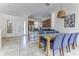 Open-concept kitchen and dining area with modern appliances and a large dining table at 2662 Roadster Ln, Kissimmee, FL 34746