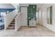 Inviting entryway featuring stylish decor, modern tile flooring, and staircase access at 2662 Roadster Ln, Kissimmee, FL 34746