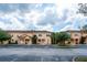 Charming condos with a red tile roof, set against a partly cloudy sky at 2662 Roadster Ln, Kissimmee, FL 34746